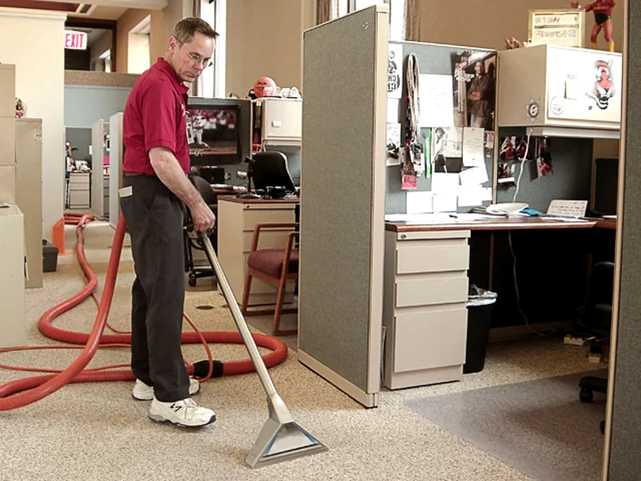 Technician cleaning carpet in an office